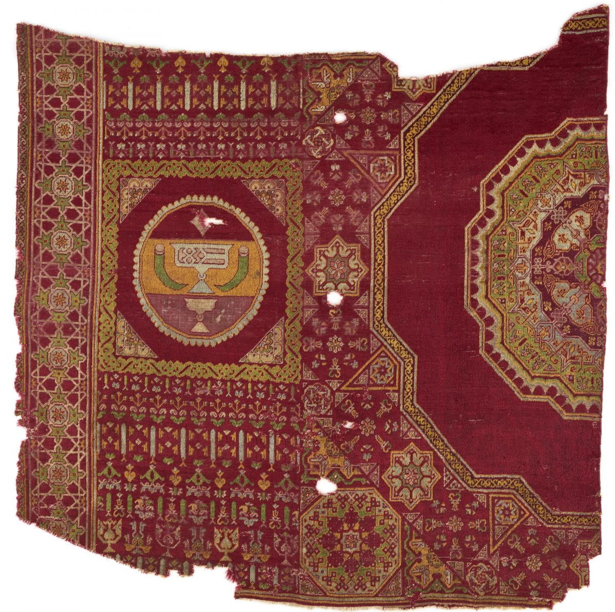 Carpet fragment with central lobed octagonal medallion on a red ground