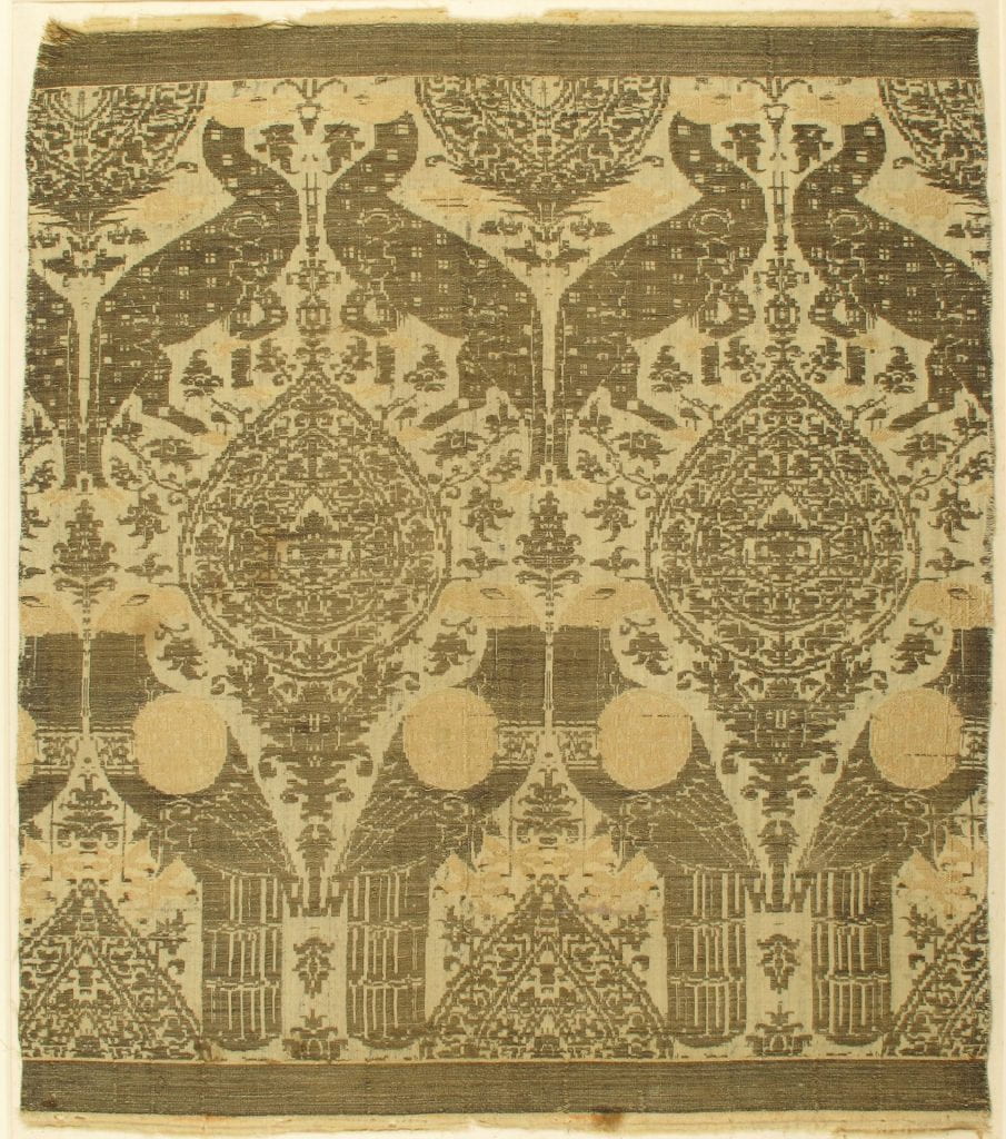A textile with similar patterns of archways and geometric design.