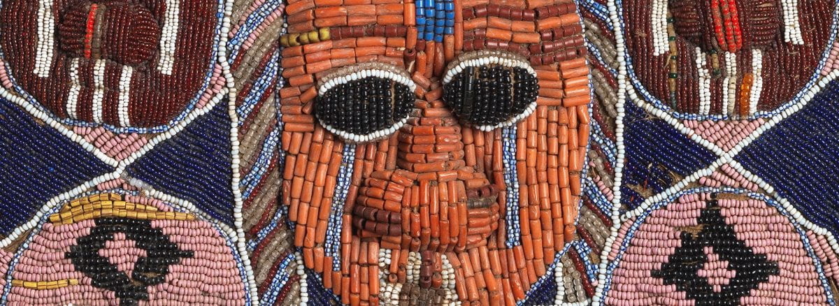 Detail of beaded bag with mask in relief