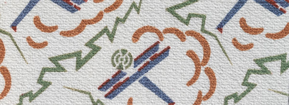 White textile fragment with print of blue planes, green electricity, and orange cloud motifs.