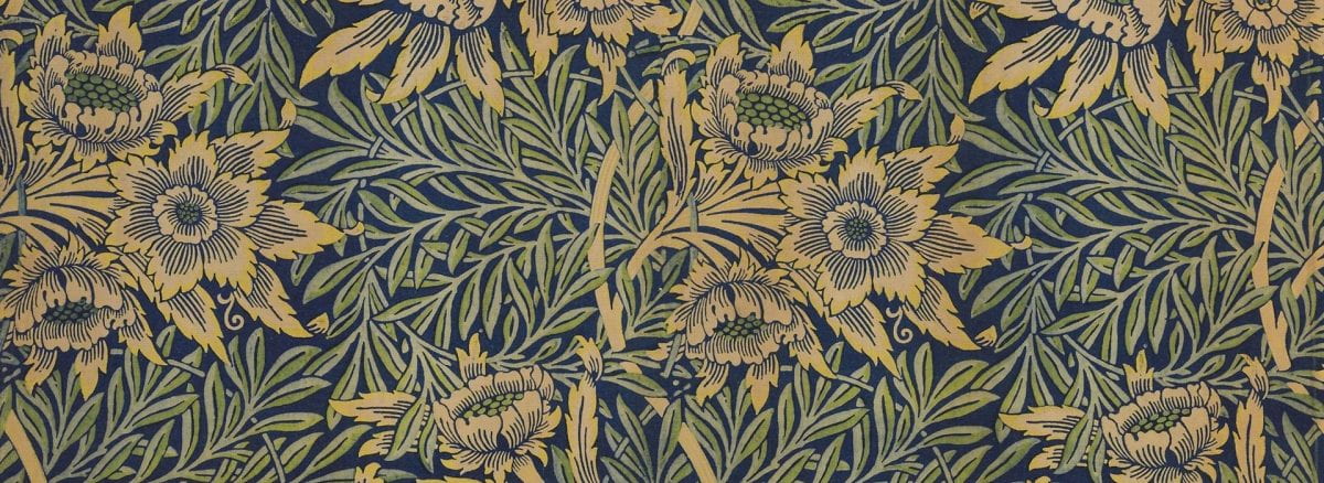 Detail of a textile with a repeating floral pattern in blue, green and yellow