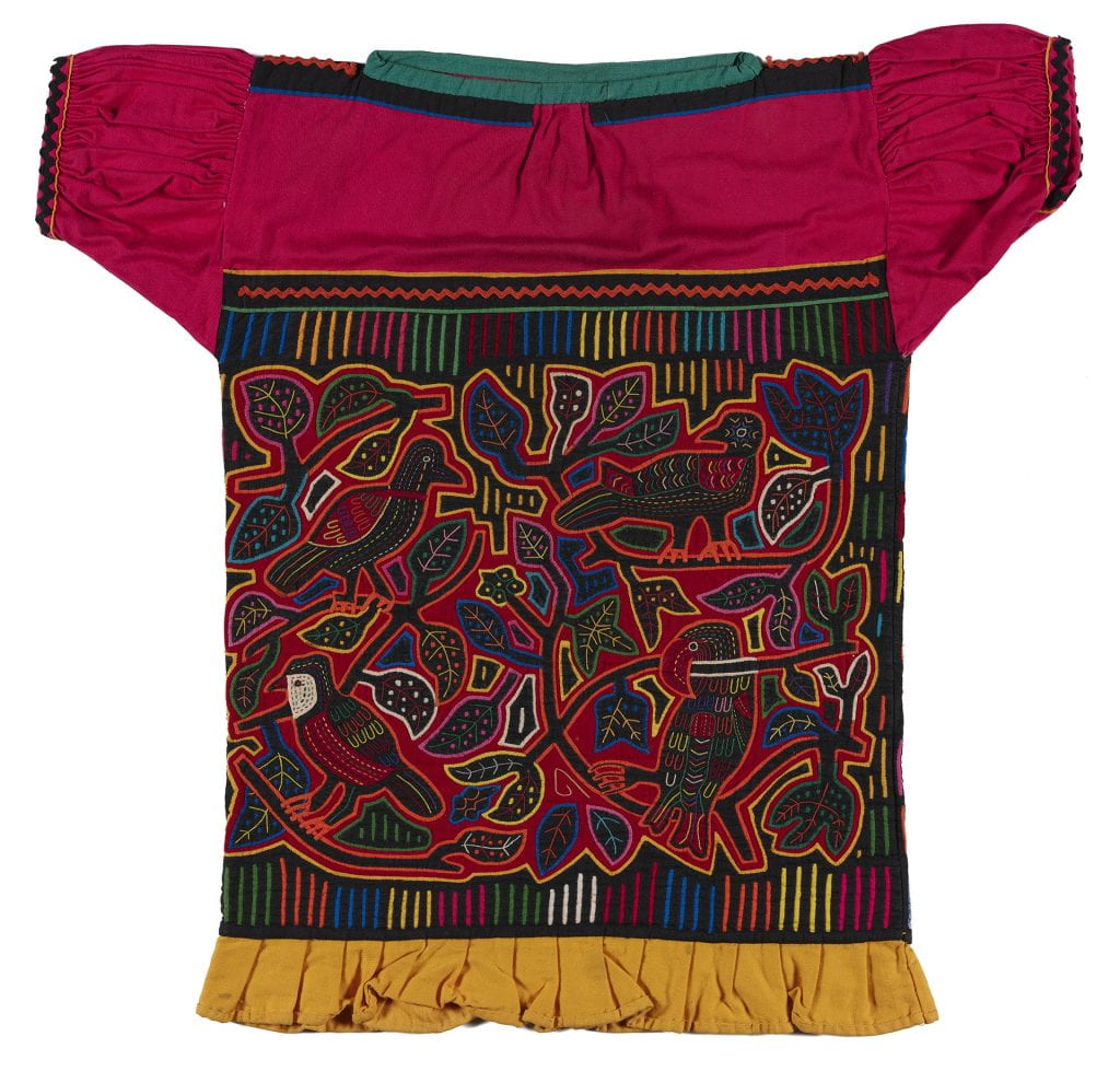 Machine-made blouse in reverse applique technique. Hot pink yoke and sleeves, yellow ruffle on lower edge. Black ground, red lining, elongated fillers. Design of birds and leaves.