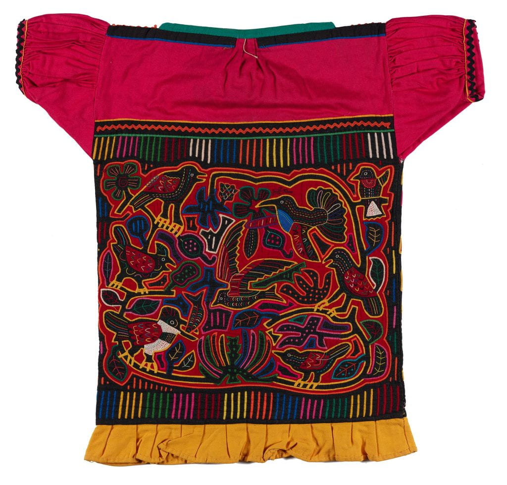 Machine-made blouse in reverse applique technique. Hot pink yoke and sleeves, yellow ruffle on lower edge. Black ground, red lining, elongated fillers. Design of one side same as 1985.56.27 (birds and leaves), the o
